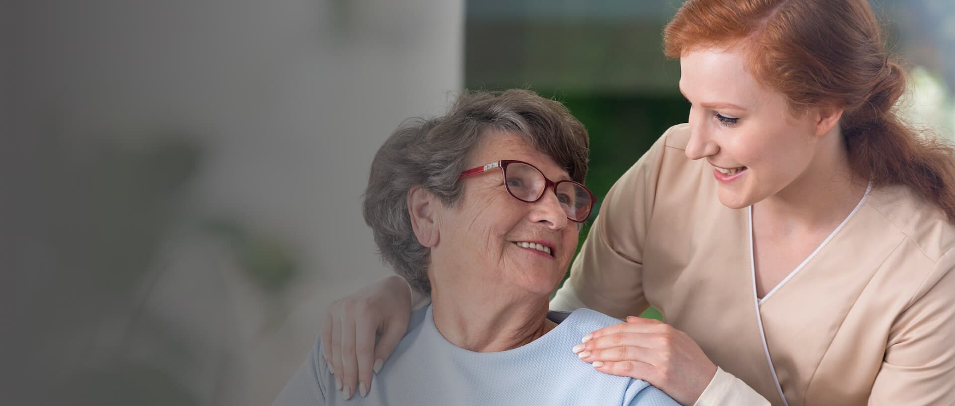 A caregiver supporting a resident with warmth and compassion